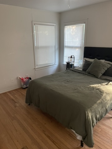 4102 Aspen Street Bryan, TX 77801 - Photo 16 of 19 a bedroom with a bed and wooden floor