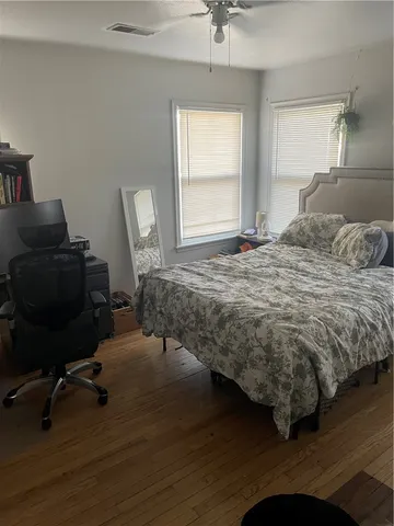 a bedroom with a bed chair and a window
