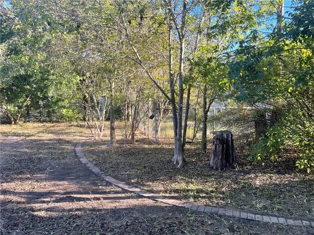 a backyard of a house with lots of trees