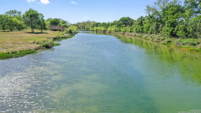 a view of a lake with a yard