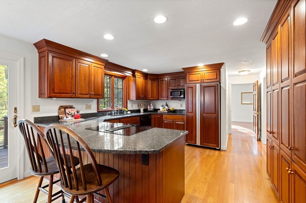 6 Cameron Road Andover, MA 01810 - Photo 4 of 42 a kitchen with stainless steel appliances granite countertop a refrigerator a sink a stove and island