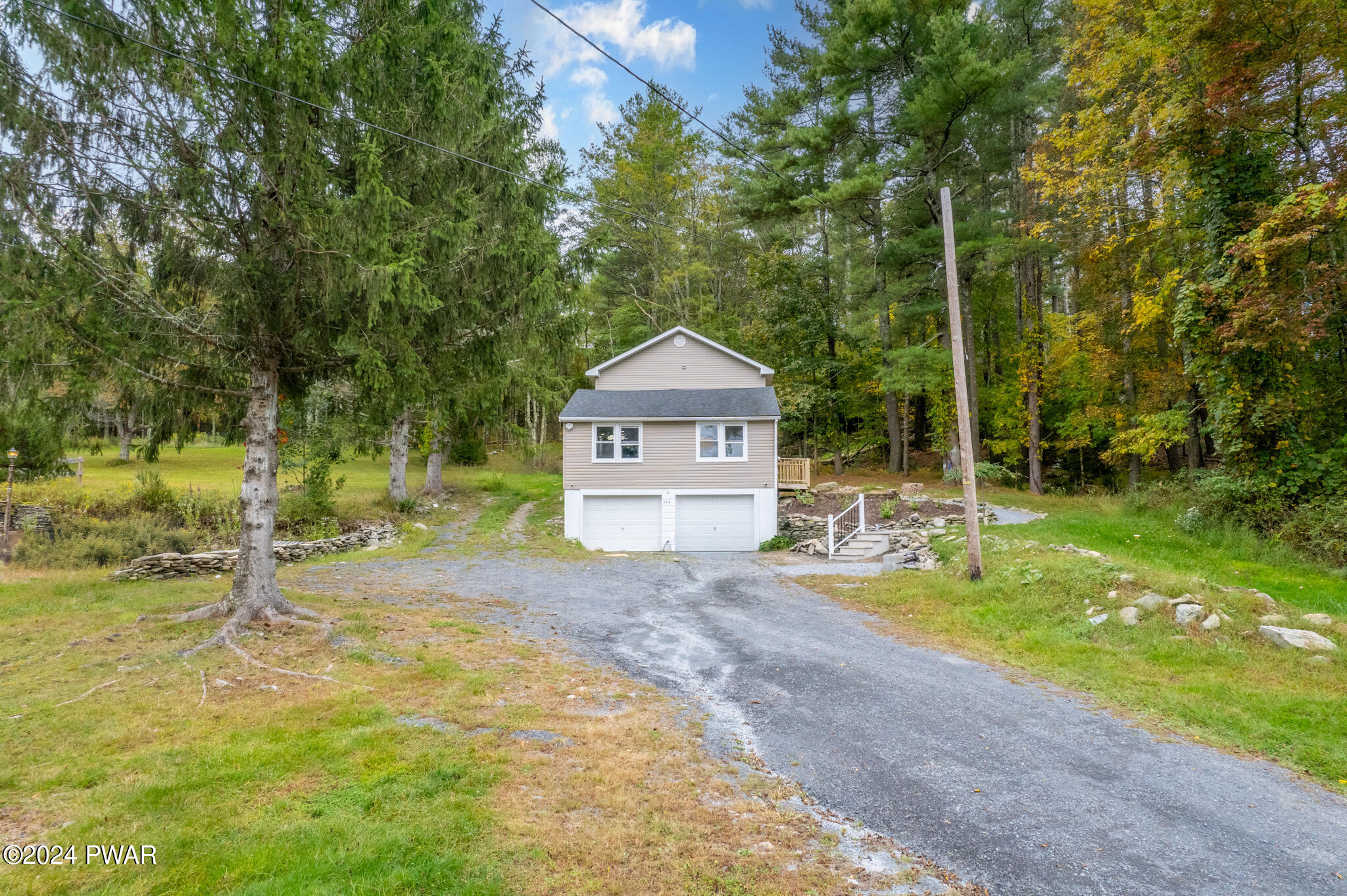 144 Log Tavern Road Milford, PA 18337 - Photo 2 of 45 a view of a house with a big yard and large trees