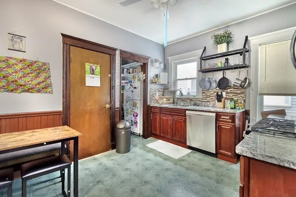 a kitchen with stainless steel appliances granite countertop a stove refrigerator and microwave