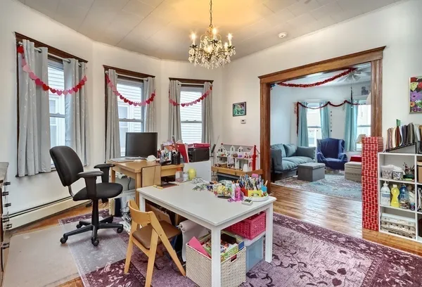 a view of a dining room with furniture window and wooden floor