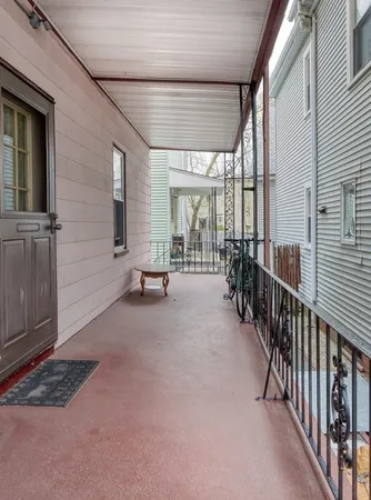 a view of a porch with wooden floor and fence