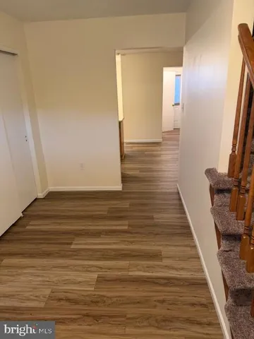 a view of a room with wooden floor