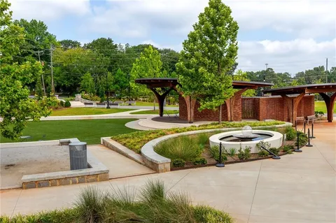 a swimming pool with outdoor seating and garden