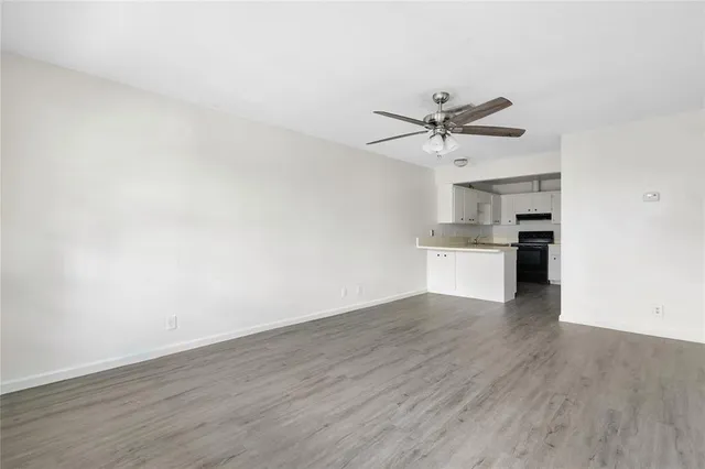 a view of a kitchen with wooden floor and a sink