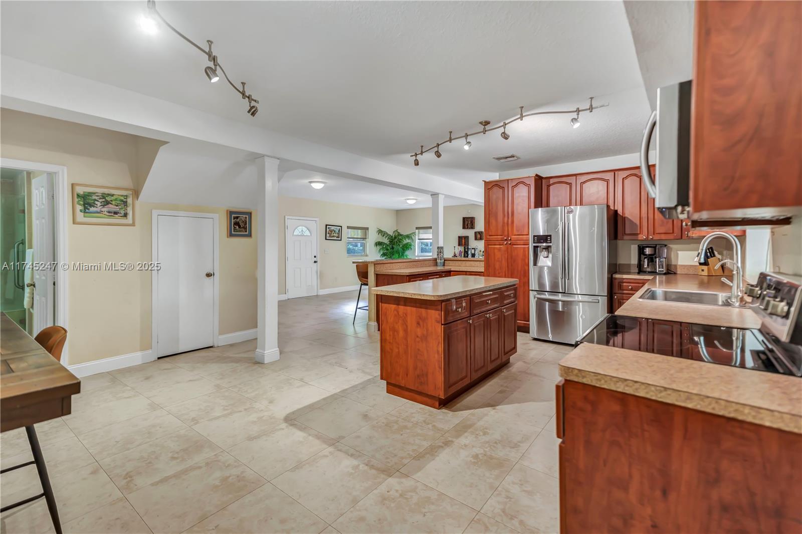 15101 Southwest 27th Street Davie, FL 33331 - Photo 14 of 100 a kitchen with stainless steel appliances granite countertop a sink and a refrigerator