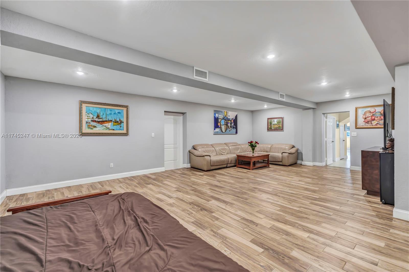 15101 Southwest 27th Street Davie, FL 33331 - Photo 21 of 100 a bed room with furniture and a flat screen tv