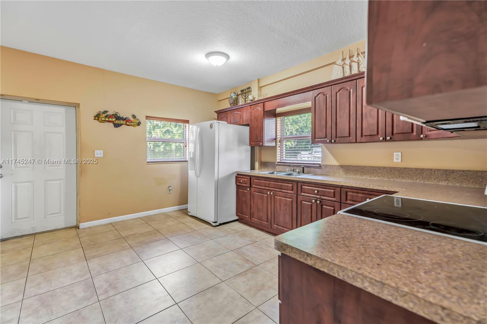 15101 Southwest 27th Street Davie, FL 33331 - Photo 26 of 100 a kitchen with stainless steel appliances granite countertop a sink a stove a microwave a counter top and cabinets