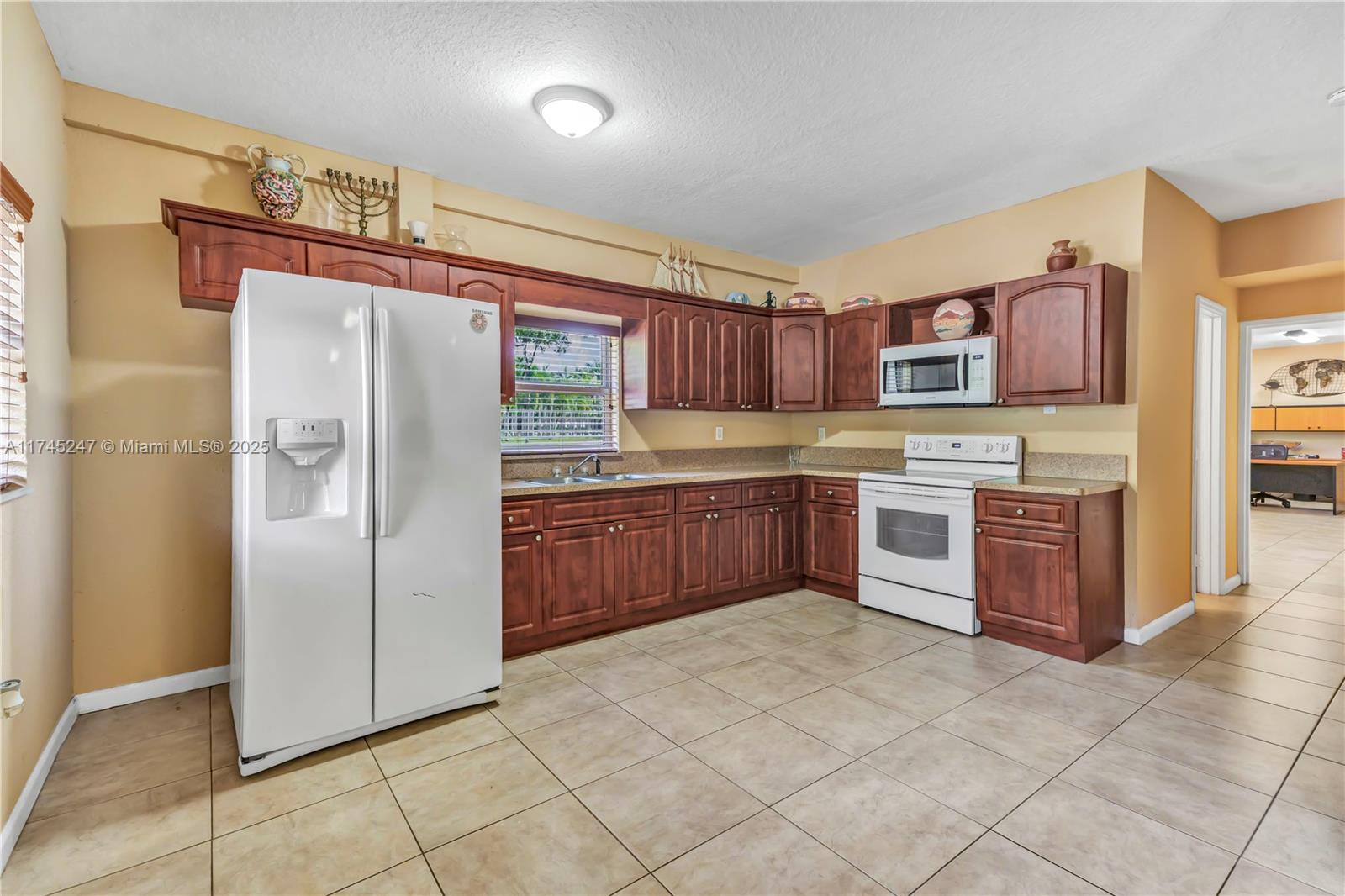 15101 Southwest 27th Street Davie, FL 33331 - Photo 27 of 100 a kitchen with stainless steel appliances granite countertop a refrigerator and a stove