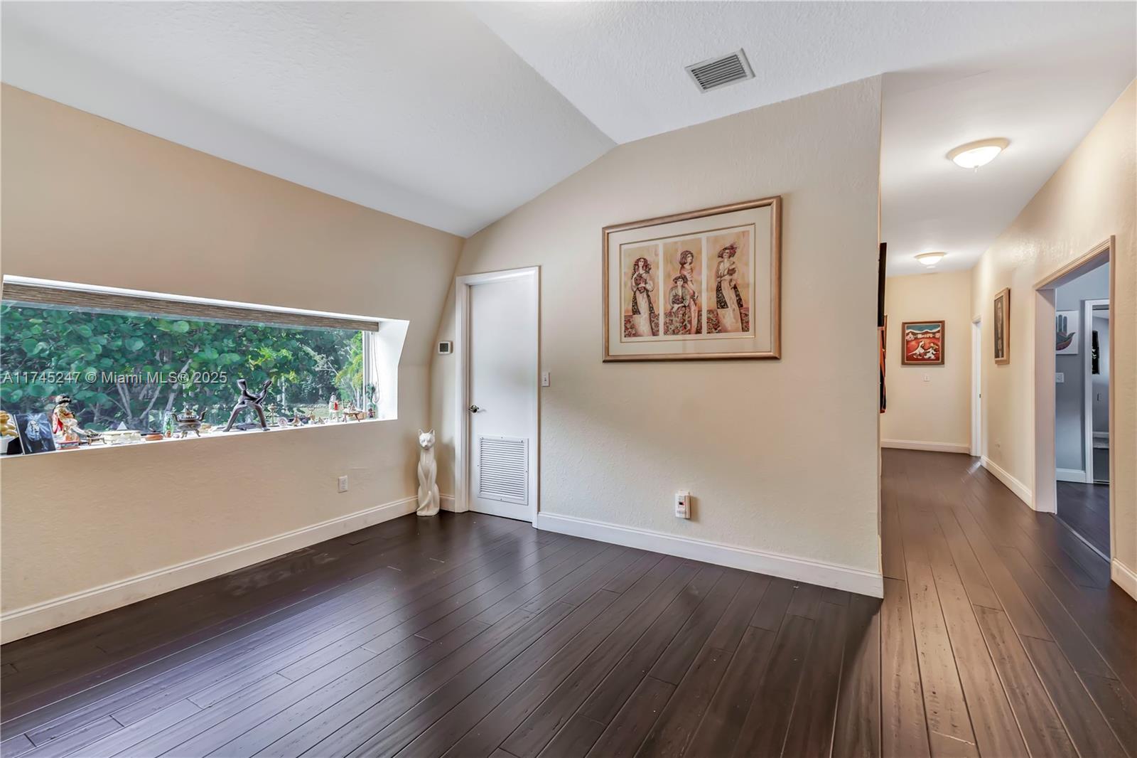 15101 Southwest 27th Street Davie, FL 33331 - Photo 34 of 100 an empty room with wooden floor and windows