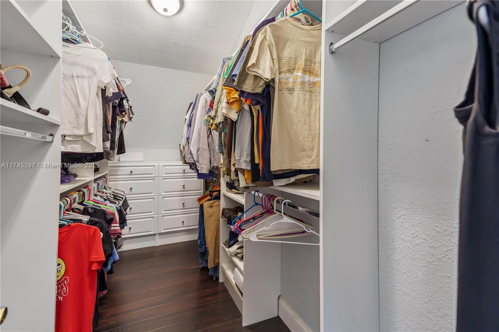 15101 Southwest 27th Street Davie, FL 33331 - Photo 39 of 100 a view of walk in closet with clothes and shoes