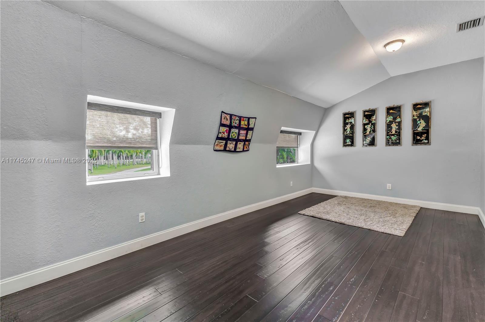 15101 Southwest 27th Street Davie, FL 33331 - Photo 41 of 100 a view of an empty room with wooden floor and a window