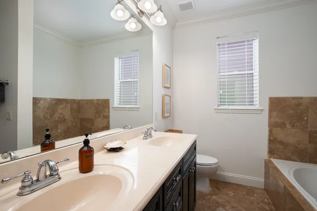 a bathroom with a sink a toilet and mirror