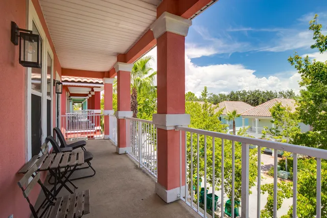 a view of a chairs and table in the balcony