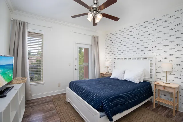 a bedroom with a bed and a flat tv screen on dresser