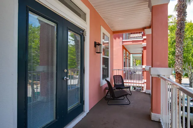 a balcony with furniture and a potted plant