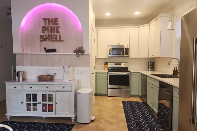 a kitchen with a stove a sink and a refrigerator