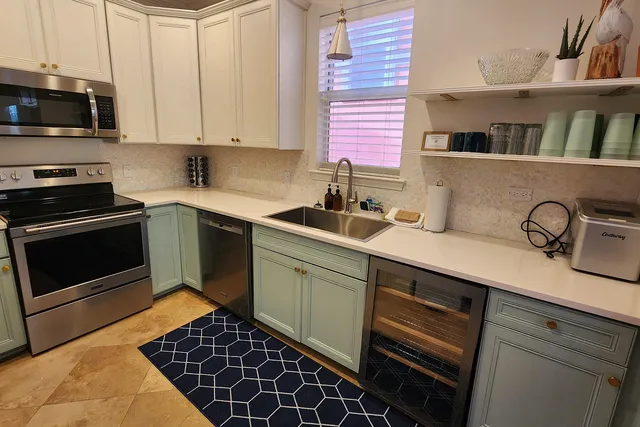 a kitchen with a sink stove and cabinets