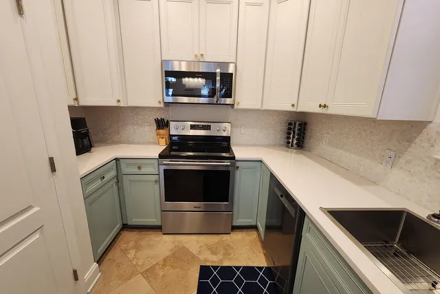 a kitchen with a sink and white cabinets
