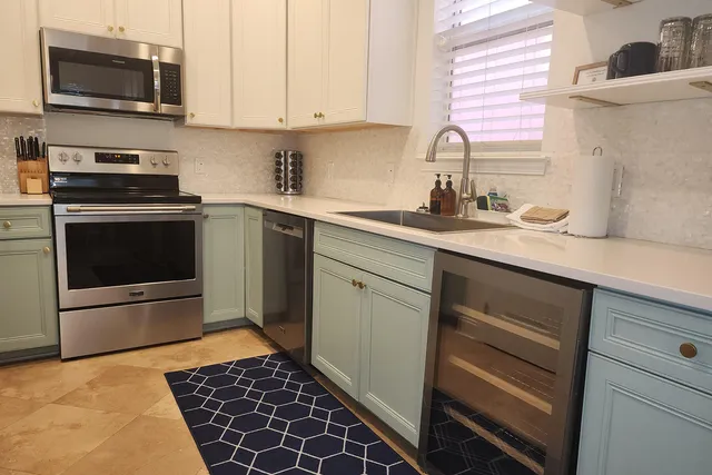 a kitchen with a sink stove and microwave