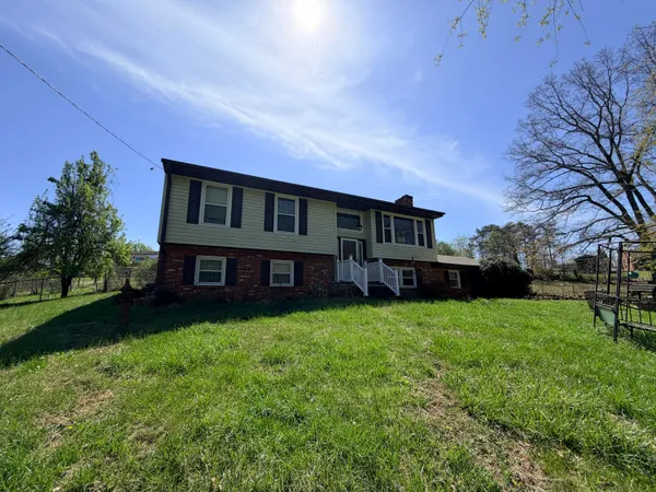 a view of house with yard and entertaining space