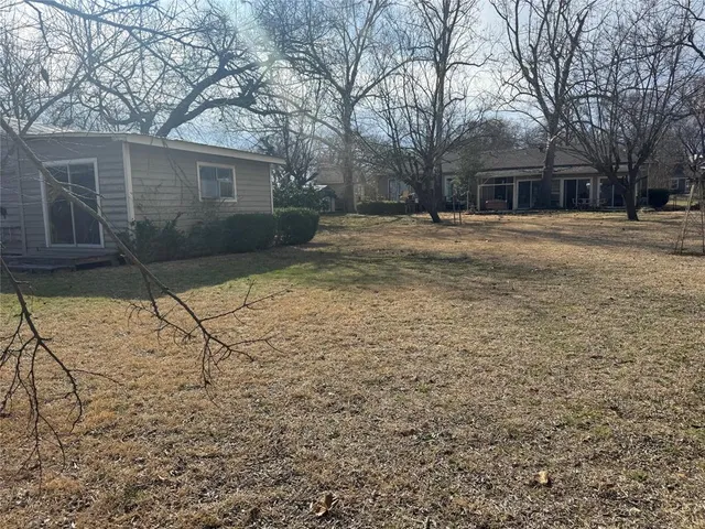 a backyard of a house with large trees