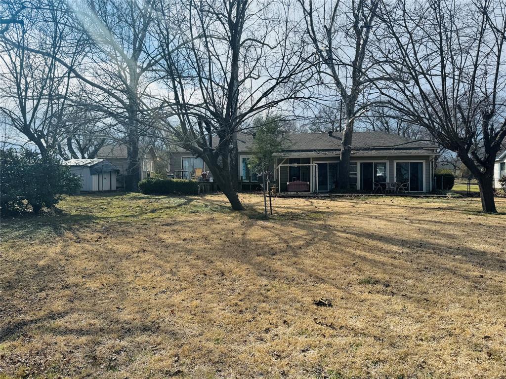 429 South Broadway Street Bells, TX 75414 - Photo 4 of 18 a house with trees in front of it