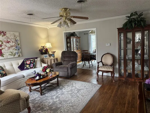 a living room with furniture a rug and a chandelier