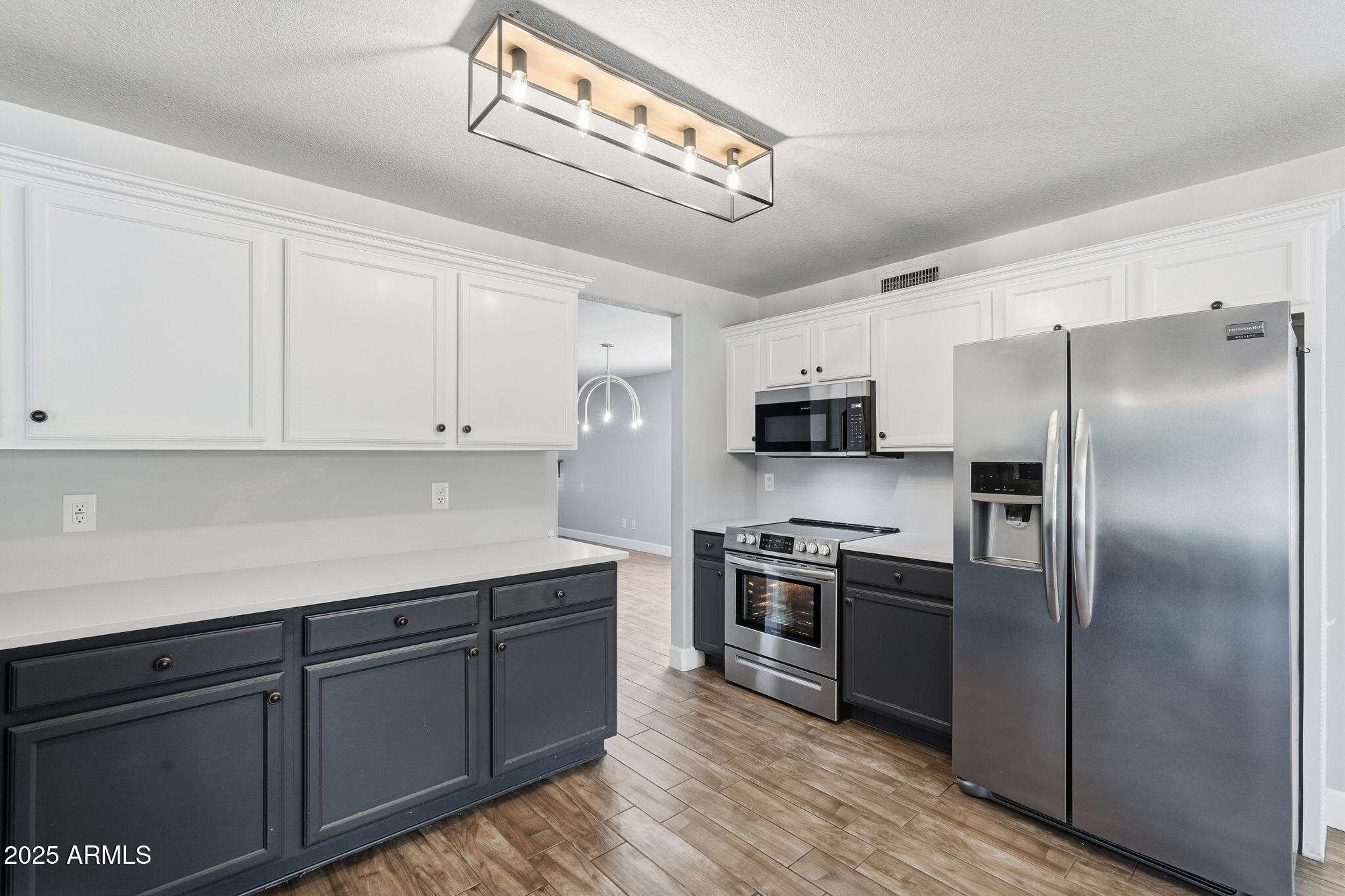 544 West Aviary Way Gilbert, AZ 85233 - Photo 14 of 45 a kitchen with stainless steel appliances granite countertop a refrigerator a sink dishwasher a oven with white cabinets and wooden floor