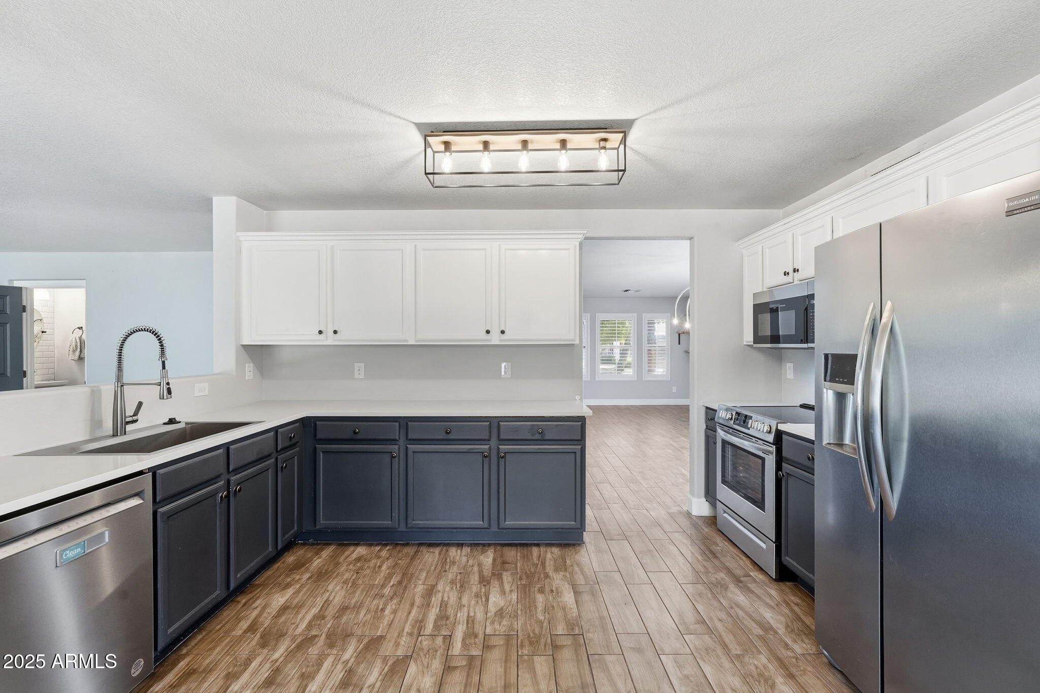 544 West Aviary Way Gilbert, AZ 85233 - Photo 15 of 45 a kitchen with stainless steel appliances granite countertop a sink stove and refrigerator