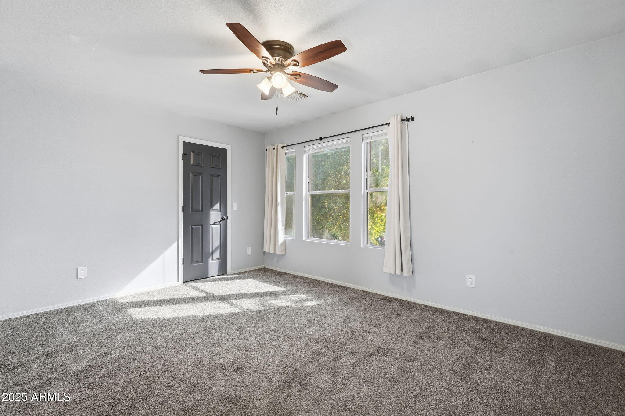 544 West Aviary Way Gilbert, AZ 85233 - Photo 24 of 45 an empty room with windows and chandelier fan
