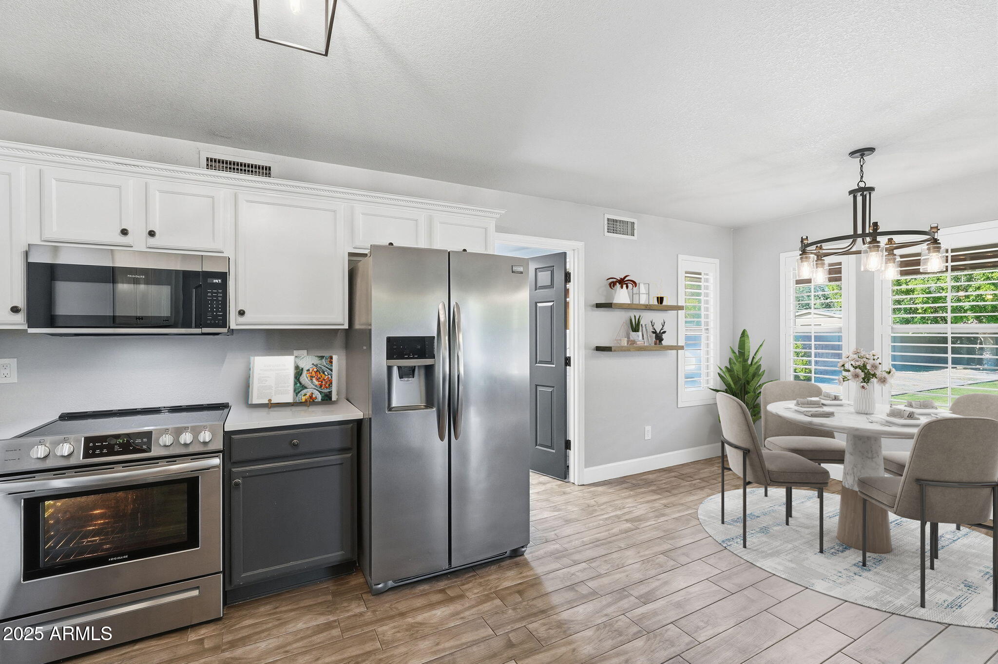 544 West Aviary Way Gilbert, AZ 85233 - Photo 3 of 45 a kitchen with granite countertop a refrigerator stove and microwave