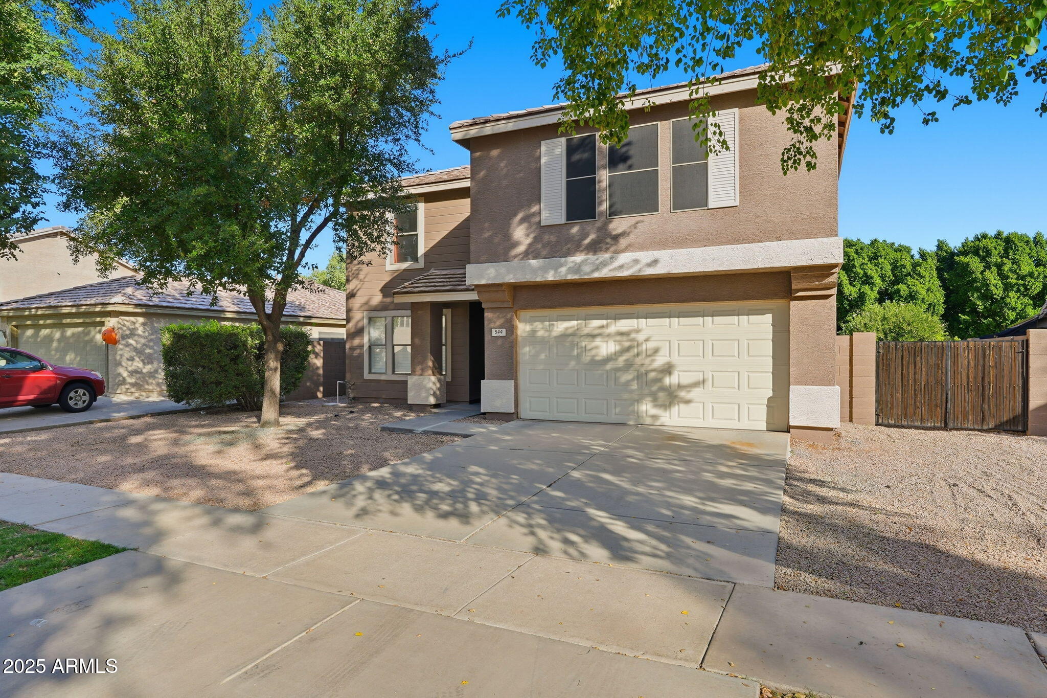 544 West Aviary Way Gilbert, AZ 85233 - Photo 33 of 45 a front view of a house with a yard and a garage