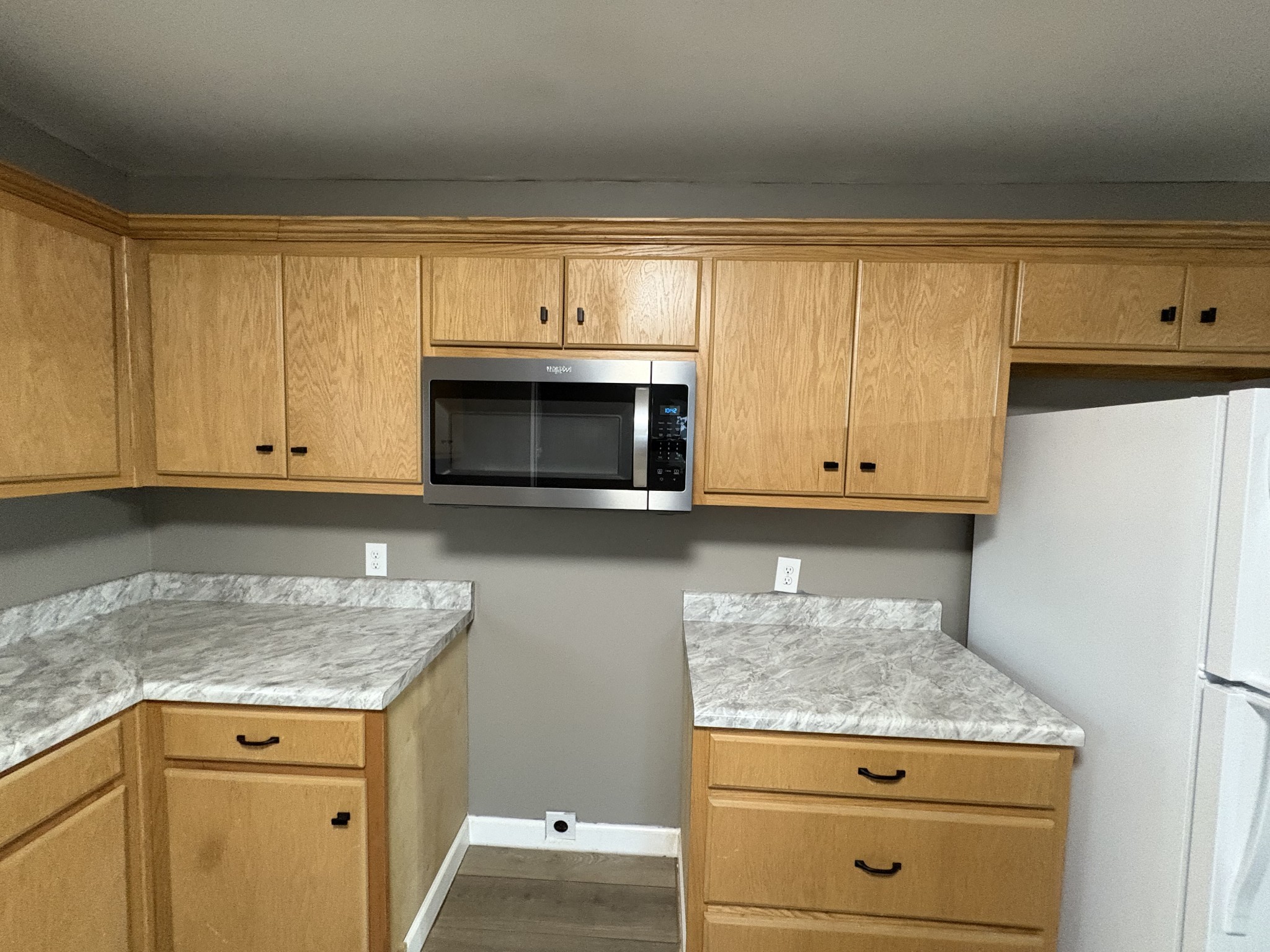 134 Elm Street Pulaski, TN 38478 - Photo 17 of 34 a kitchen with granite countertop cabinets stainless steel appliances and a counter space