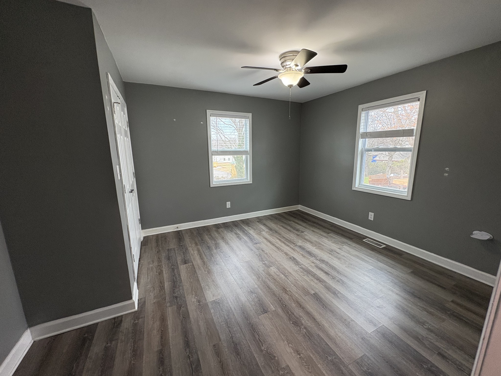 134 Elm Street Pulaski, TN 38478 - Photo 21 of 34 a view of an empty room with a window and wooden floor