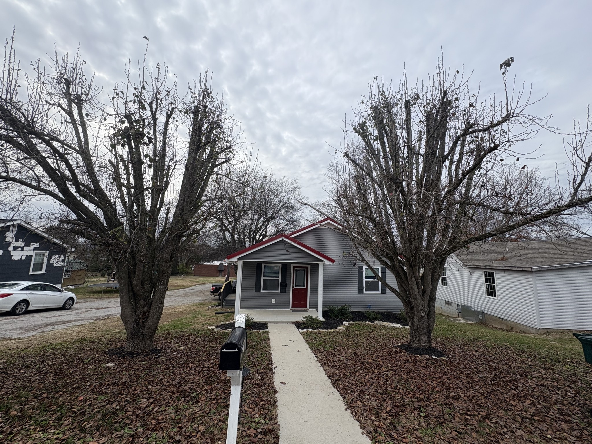 134 Elm Street Pulaski, TN 38478 - Photo 3 of 34 a front view of a house with trees