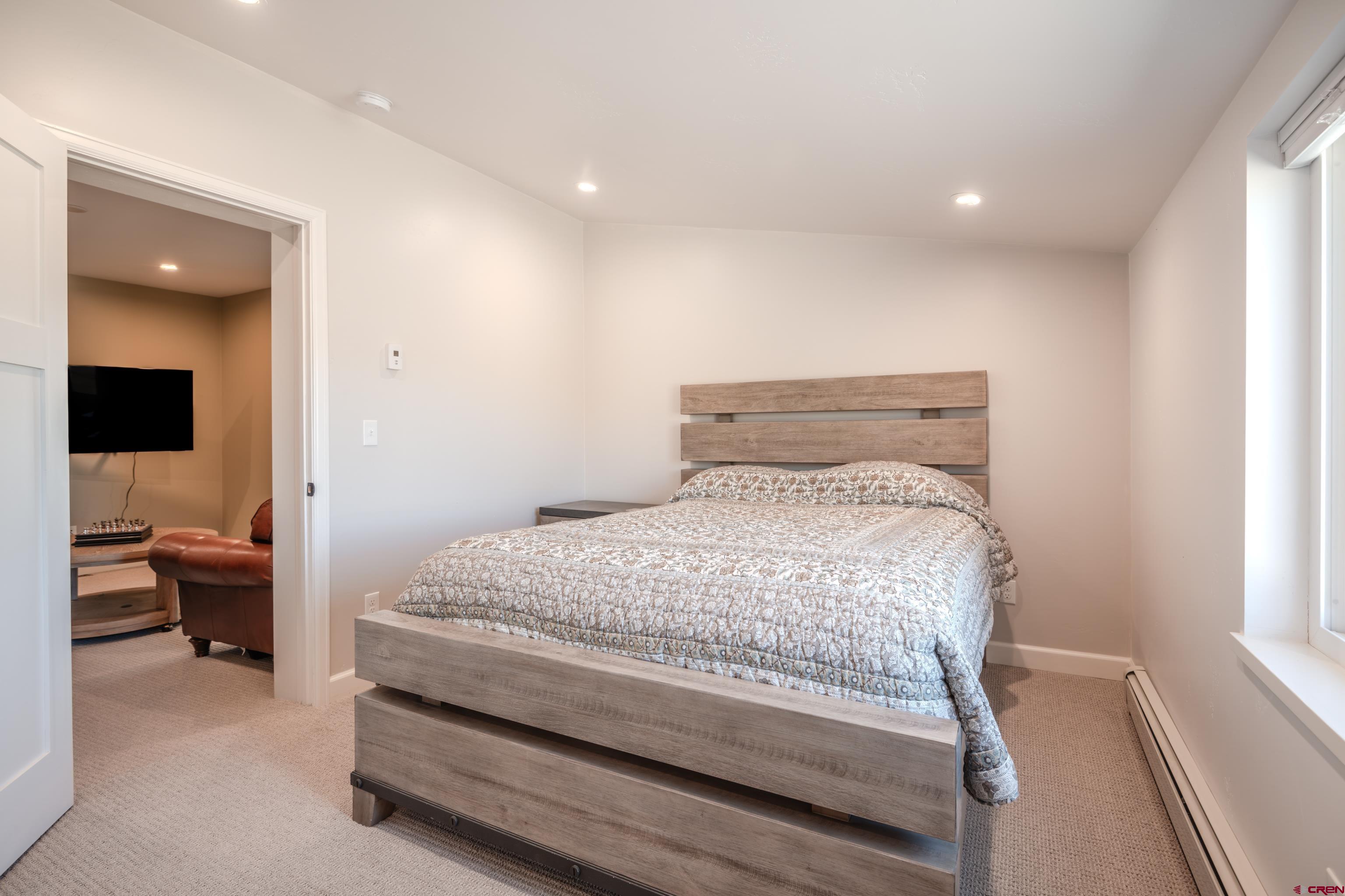 43950 Highway 50 Gunnison, CO 81230 - Photo 15 of 45 a bedroom with a bed and furniture