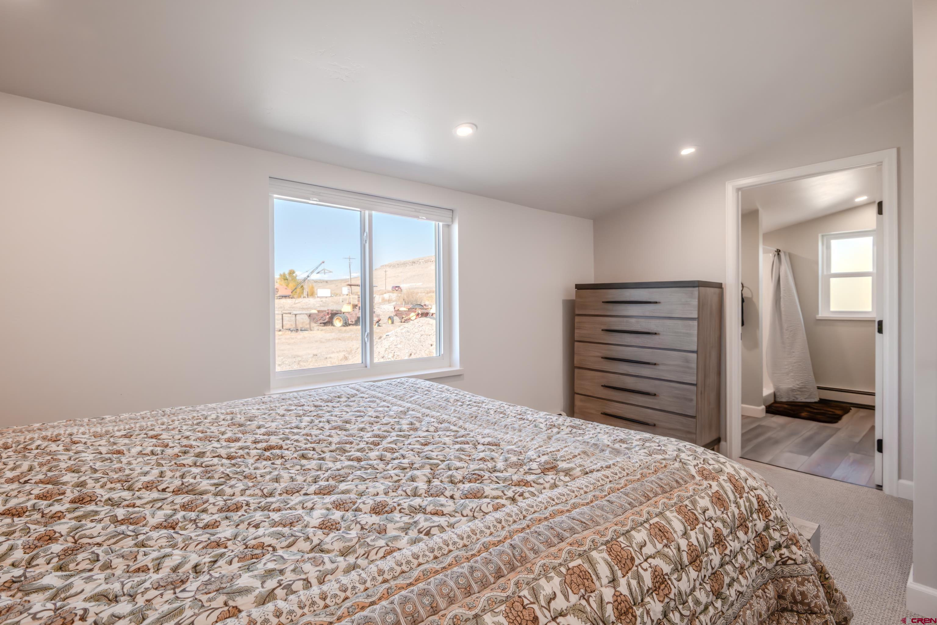 43950 Highway 50 Gunnison, CO 81230 - Photo 16 of 45 a bedroom with a bed and a window