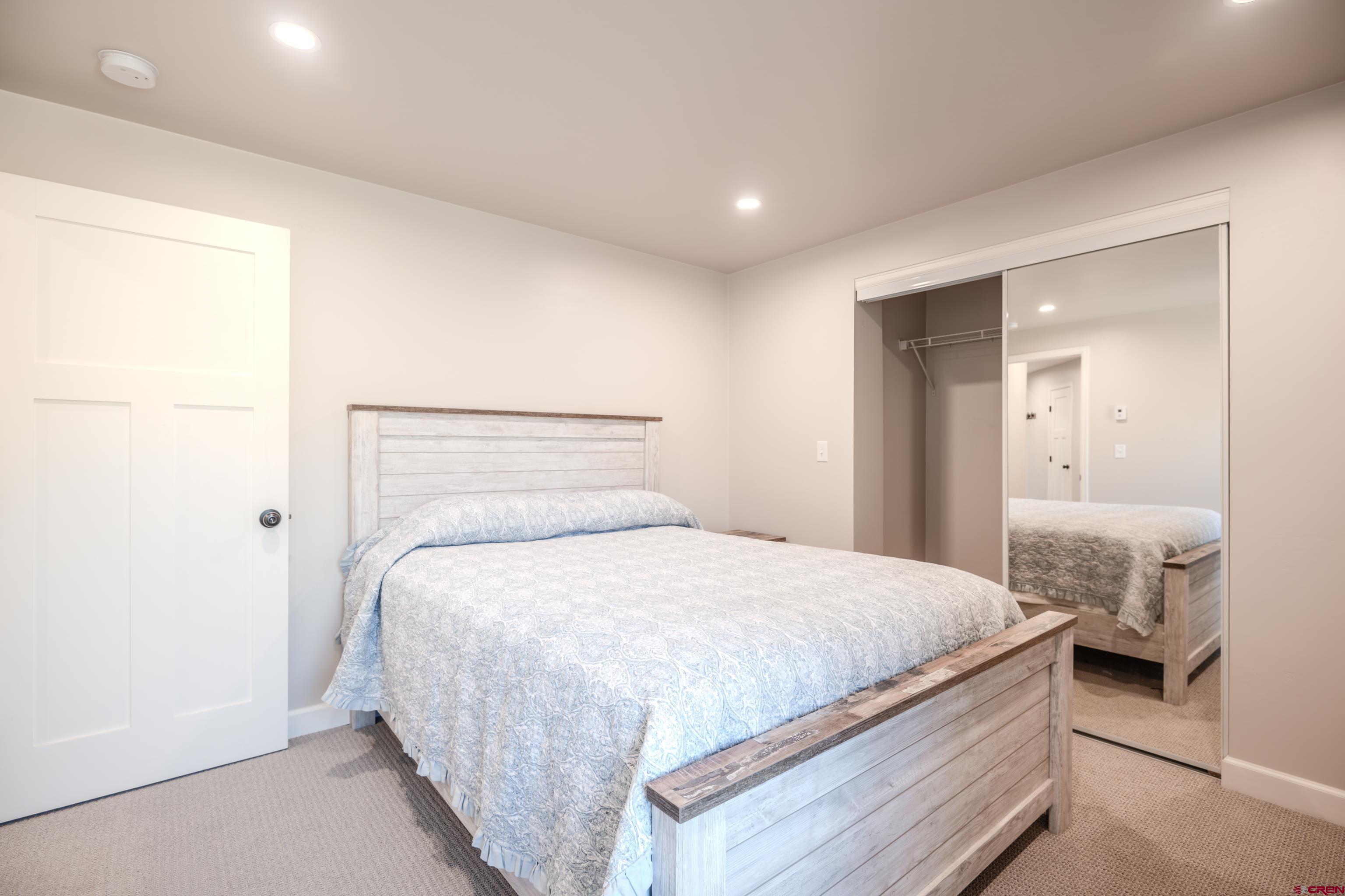 43950 Highway 50 Gunnison, CO 81230 - Photo 19 of 45 a bedroom with a bed and a mirror