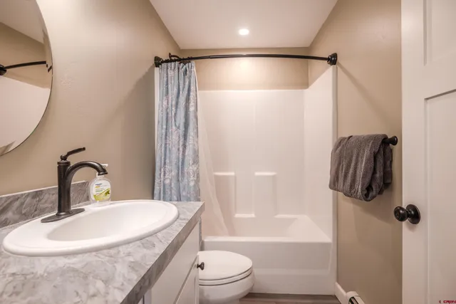 a bathroom with a sink toilet and shower