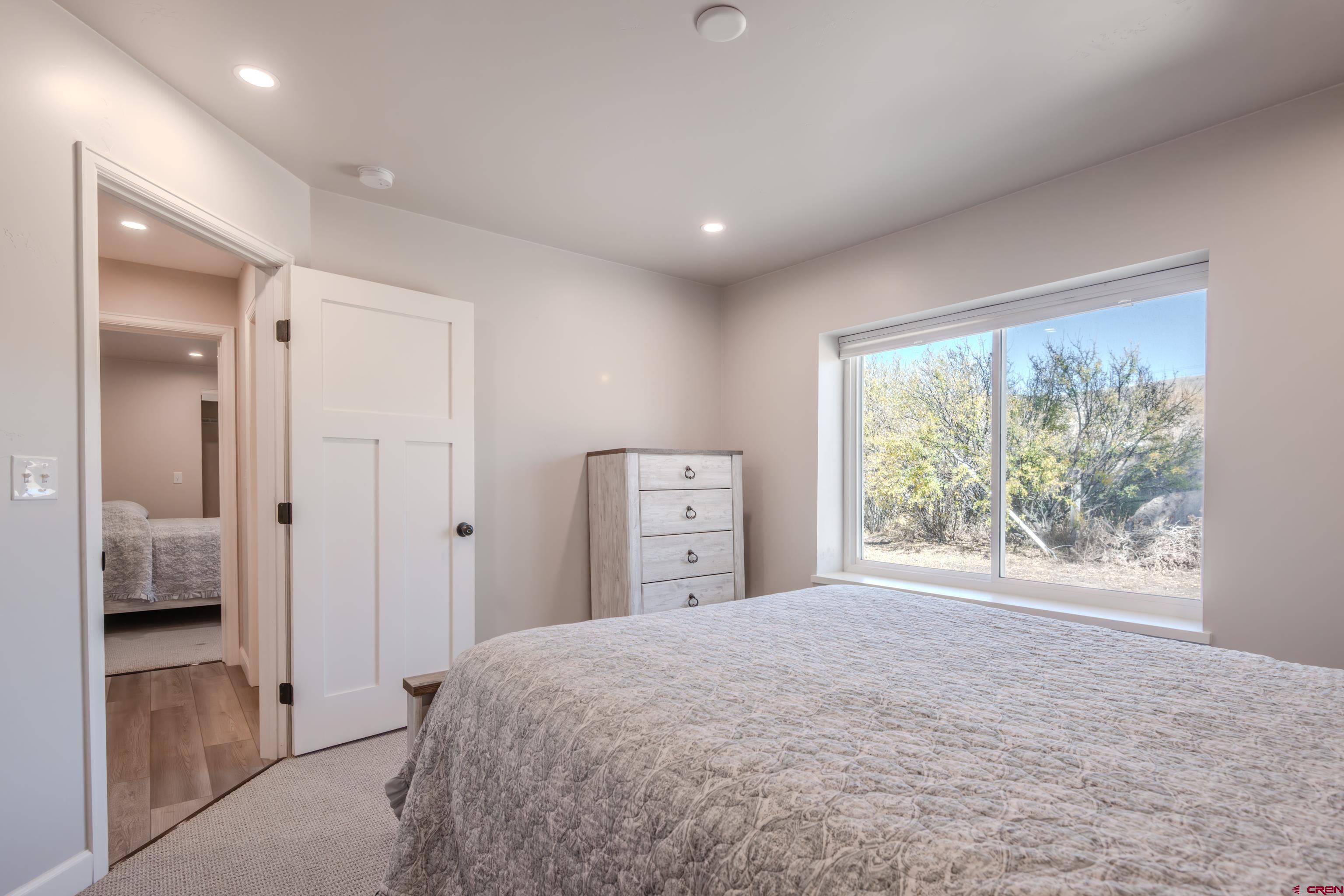 43950 Highway 50 Gunnison, CO 81230 - Photo 22 of 45 a spacious bedroom with a large bed and a large window