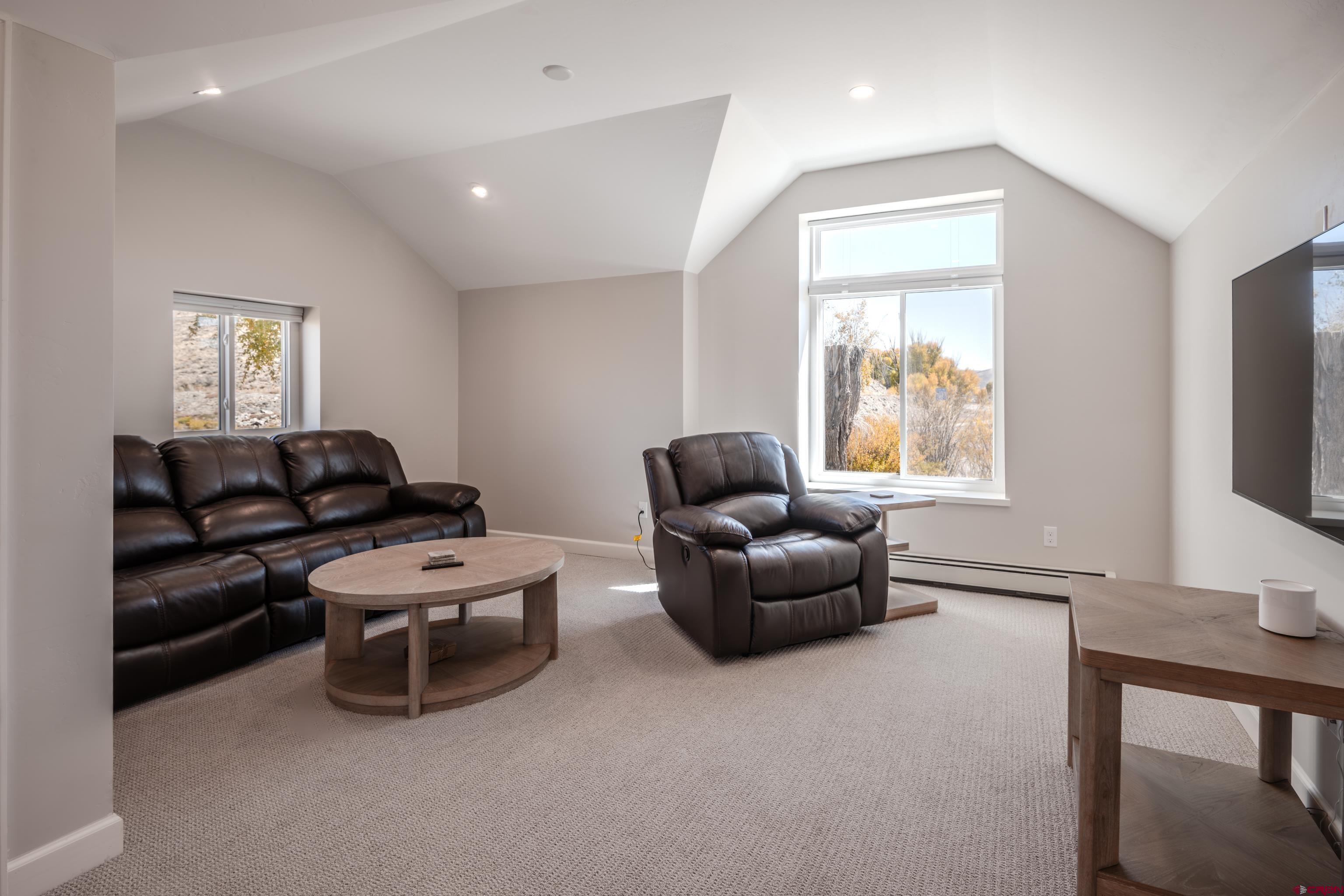 43950 Highway 50 Gunnison, CO 81230 - Photo 23 of 45 a living room with furniture a flat screen tv and a window