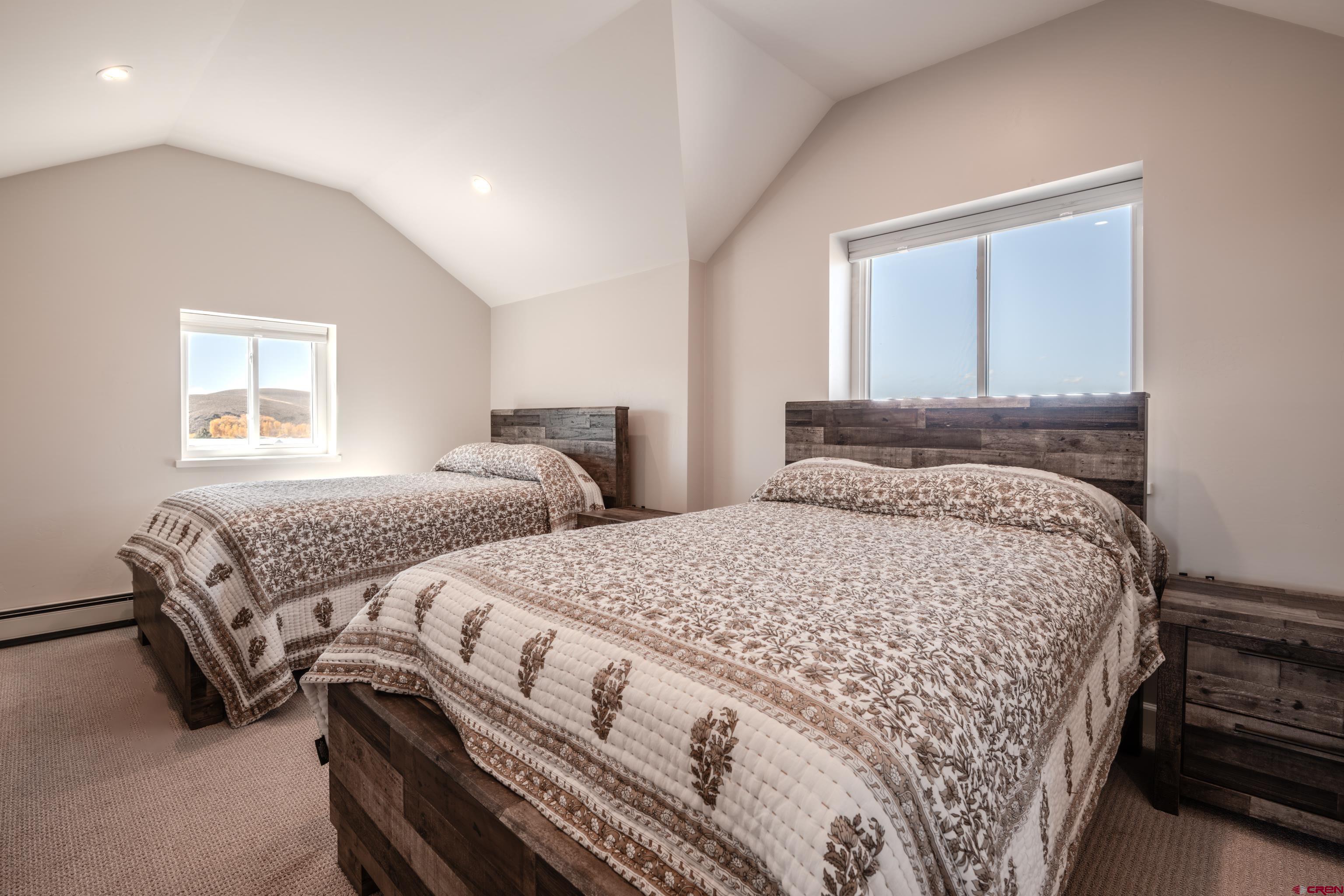 43950 Highway 50 Gunnison, CO 81230 - Photo 26 of 45 a bedroom with two beds and a window