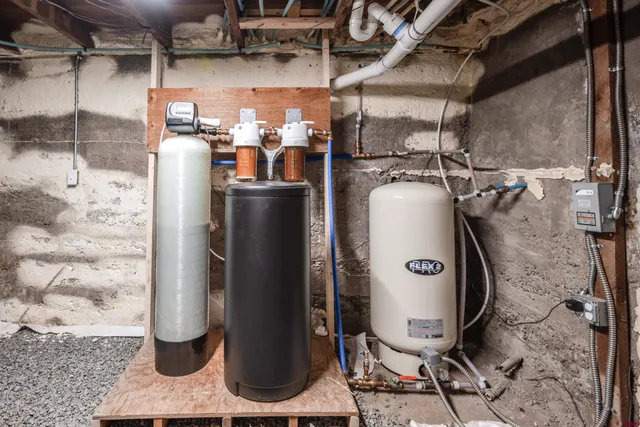 a storage room with water heater and racks