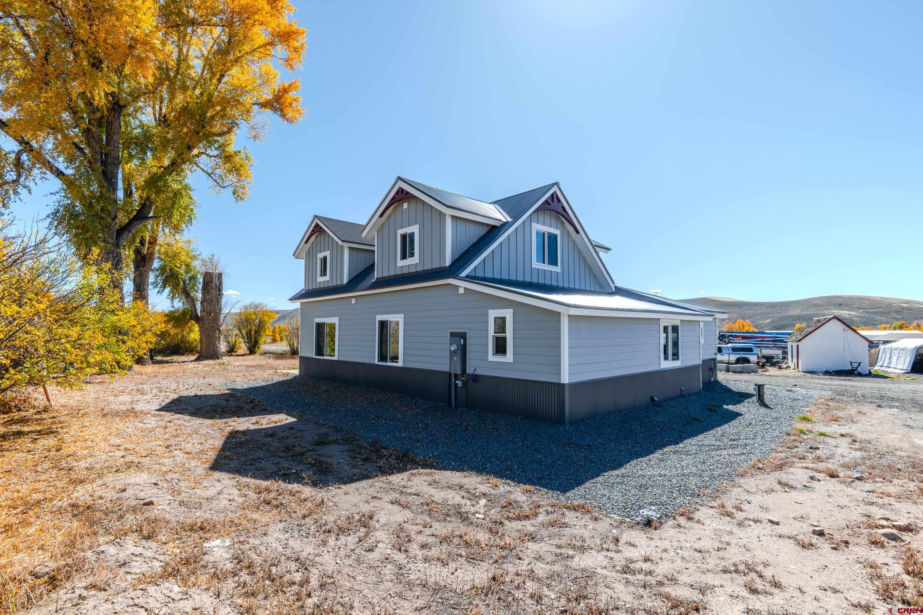 43950 Highway 50 Gunnison, CO 81230 - Photo 33 of 45 a front view of a house with a yard
