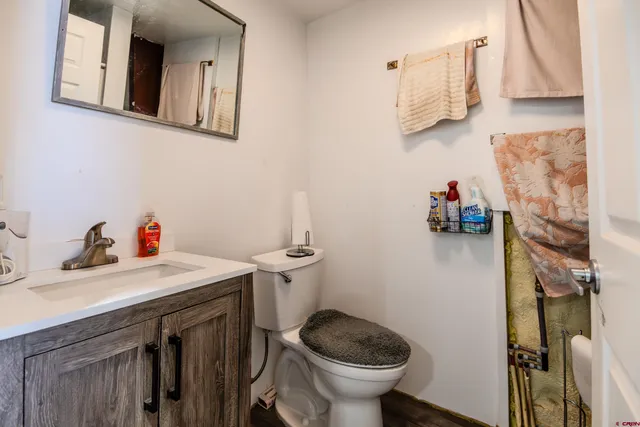 a bathroom with a sink a toilet and a mirror