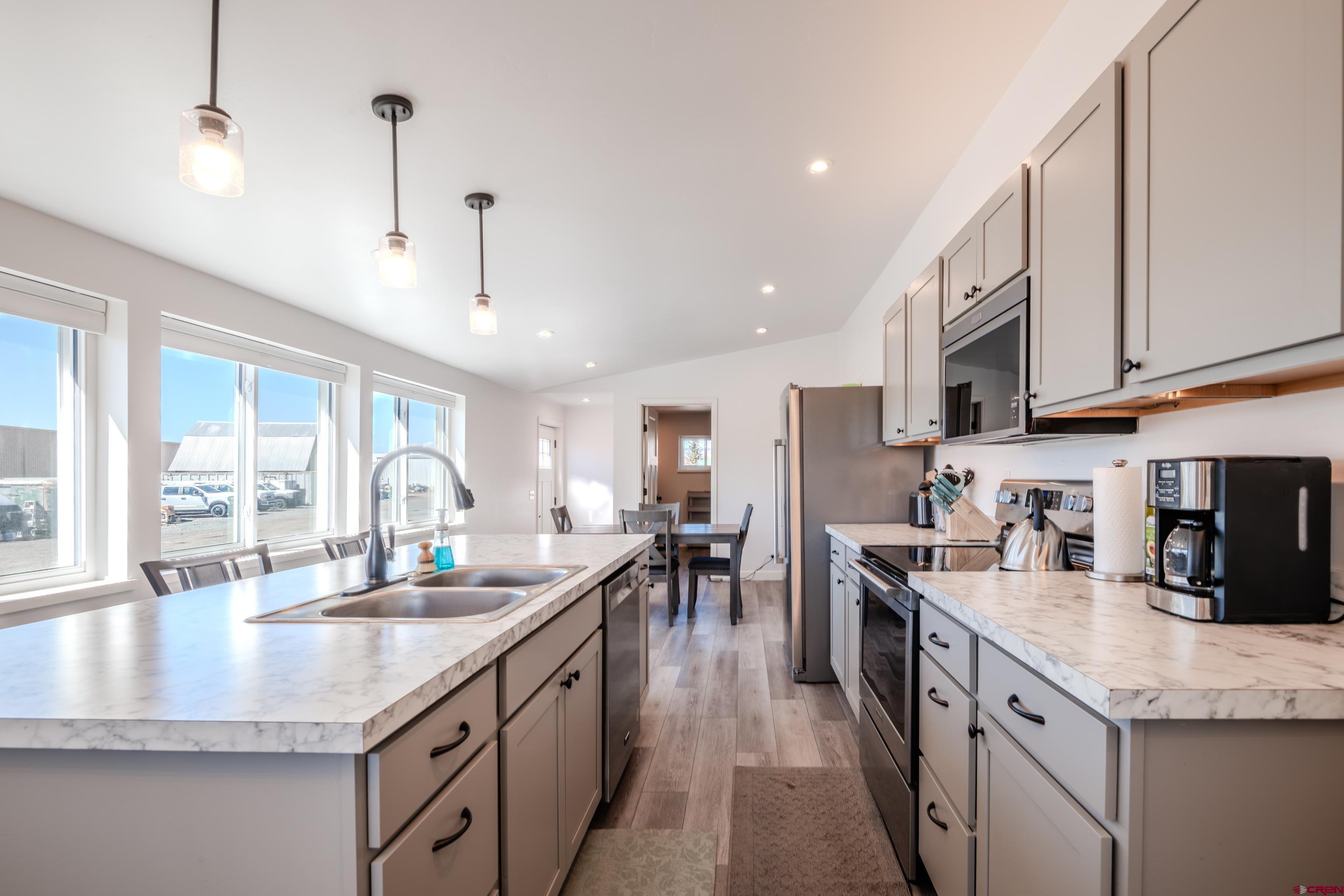 43950 Highway 50 Gunnison, CO 81230 - Photo 6 of 45 a kitchen with stainless steel appliances granite countertop a sink stove and refrigerator